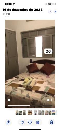 a bedroom with a bed with a comforter on it at Pousada e restaurante veredas in Piúma