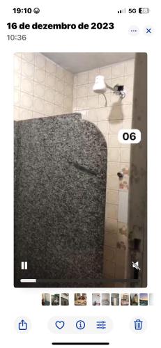a screenshot of a bathroom with a bath tub with a mirror at Pousada e restaurante veredas in Piúma