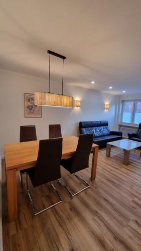 a living room with a dining table and a couch at OSTSEE FeWo by Wolf in Grömitz