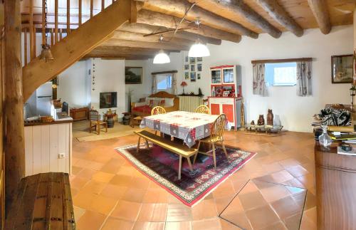 a living room with a table in the middle at Maison chaleureuse à Mont >Vue montagne & cheminée in Mont
