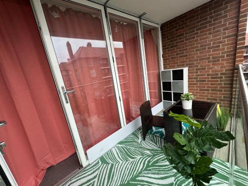 a balcony with a chair and a sliding glass door at Cosy Luxurious Room in The Heart of London in London