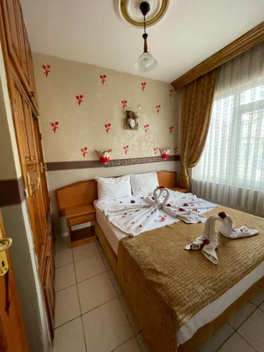 a bedroom with a bed with dolls on it at Best Life Apart Hotel in Alanya