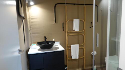 a bathroom with a sink and a shower at Magnetic Glamping in Nelly Bay