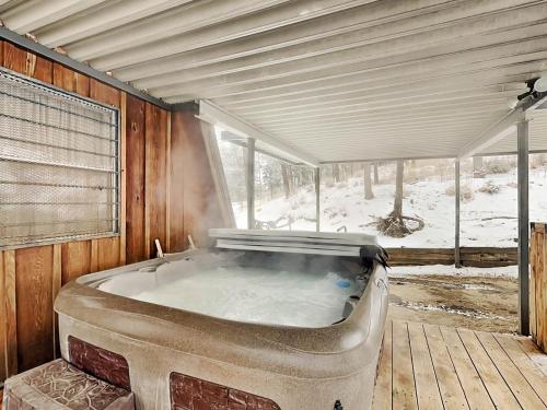 a large bath tub in a room with snow on the ground at Docs Den in Ruidoso