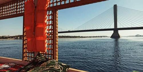 a view of a bridge from a boat in the water at Mama Africa Felucca in Aswan