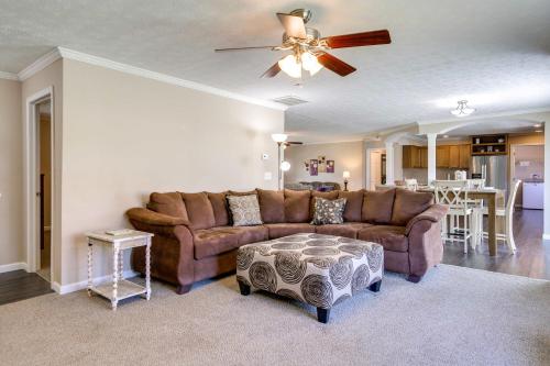 a living room with a brown couch and a table at Private Hot Tub and Mountain View Newport Home in Newport