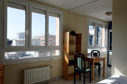 a bedroom with windows and a desk and a table at Hotel Regina & Spa in Berck-sur-Mer