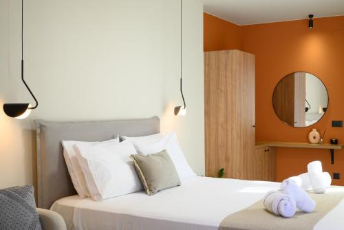 a bedroom with a large white bed with a mirror at MOD 15 City Centre in Agios Nikolaos