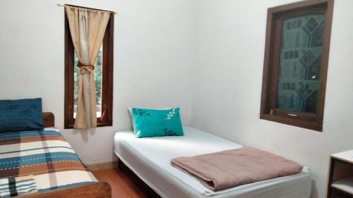 Postel nebo postele na pokoji v ubytování Homestay Rumah Bahagia Cepor