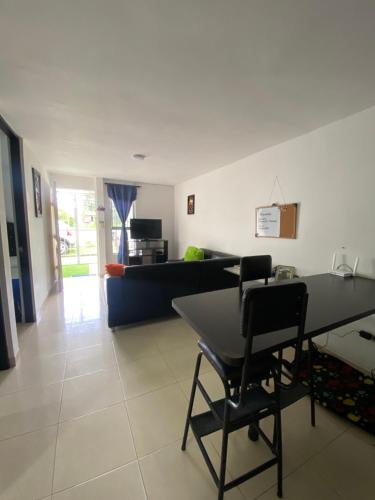 a living room with a table and a couch at Alojamiento Armenia in Armenia