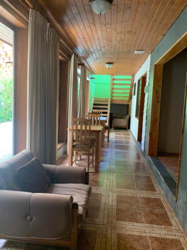 a living room with a couch and a table at Hostal Tour Pucon in Pucón