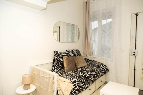 - une chambre avec un canapé à motifs zébrés et un miroir dans l'établissement Studio Stade de France 26 pour 2 personnes, à Saint-Denis