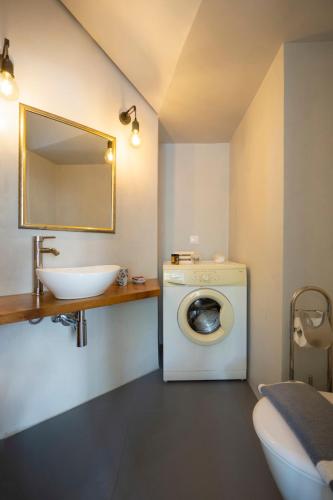 a bathroom with a washing machine and a sink at Superior Apartment Near Beach in Chania