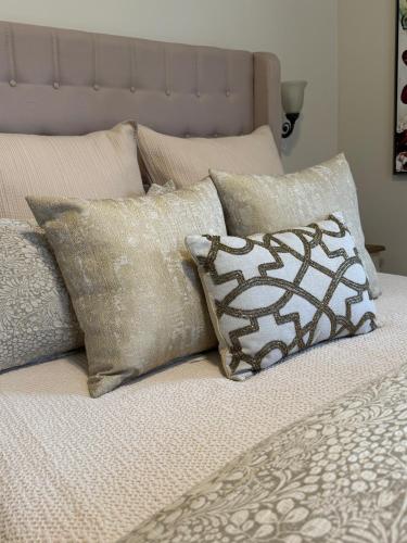 a bed with a bunch of pillows on it at Norfolk Guest House Inn in Guelph