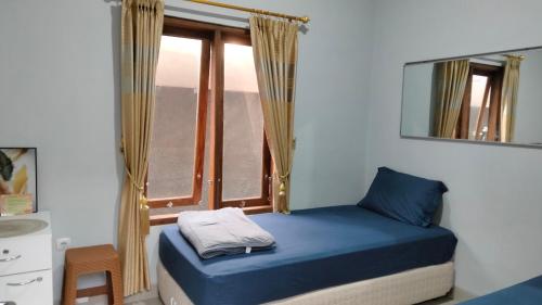 Postel nebo postele na pokoji v ubytování Homestay Rumah Bahagia Cepor