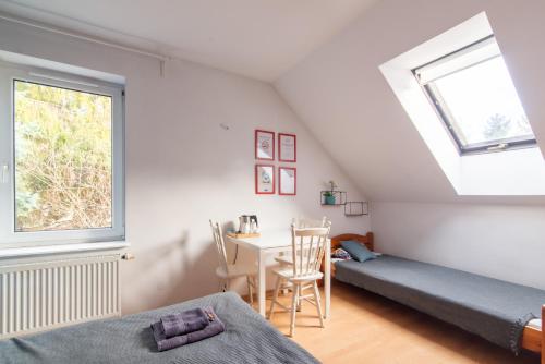 a bedroom with a bed and a desk and a window at Studio I Pokoje I Pokoje z łazienkami in Gdańsk
