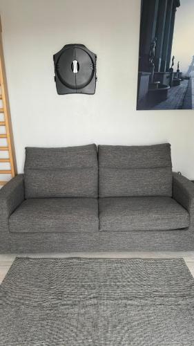 - un canapé dans le salon avec une photo sur le mur dans l'établissement Nice apartment in Saint Germain En Laye, à Saint-Germain-en-Laye