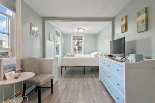 a bedroom with a bed and a tv in it at The Inn At Ocean Grove in Ocean Grove