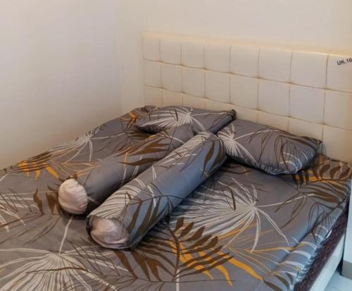 a bed with two pillows on top of it at Budget-Friendly Staycation in Tokyo Riverside PIK2 in Gedong