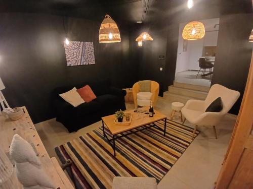 a living room with a couch and a table and chairs at Gite chez Martin in Jalhay
