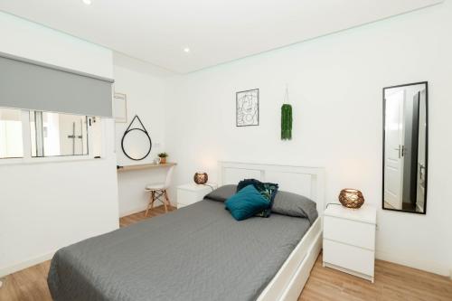 a bedroom with a bed and a mirror at NayJay Staycation in Portimão