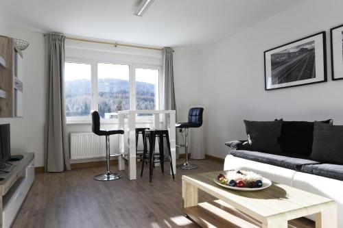 a living room with a couch and a table at Oberwiesenthal Apartments in Kurort Oberwiesenthal