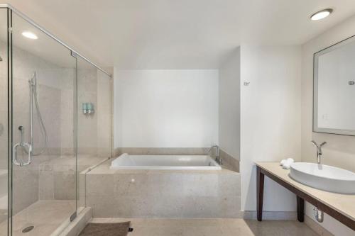 a bathroom with a tub and a sink and a shower at Sky High Penthouse Corner 2BR 2BA Icon Brickell in Miami