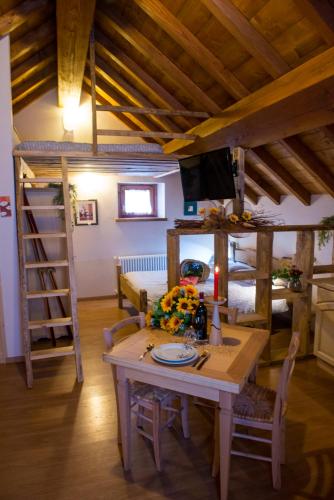 a room with a table and a bunk bed at Il Borgo Dei Celti in Fiumalbo