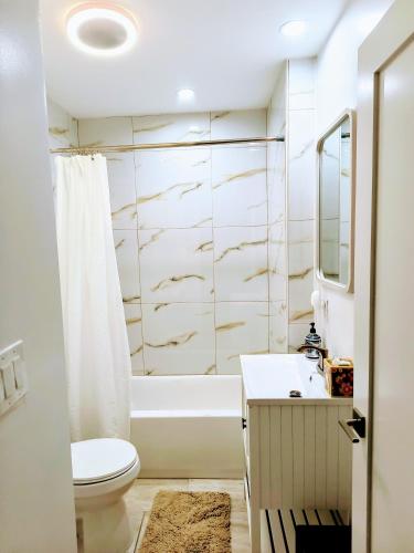 a bathroom with a tub and a toilet and a sink at My Cozy Beach House Cape May Court House NJ Pool Near Wildwood and Cape May in Whitesboro