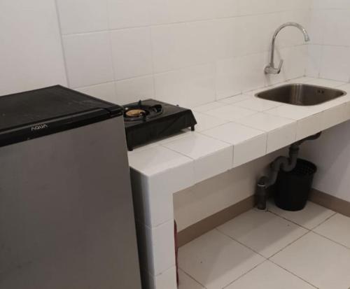 a kitchen with a sink and a counter top at Budget-Friendly Staycation in Tokyo Riverside PIK2 in Gedong
