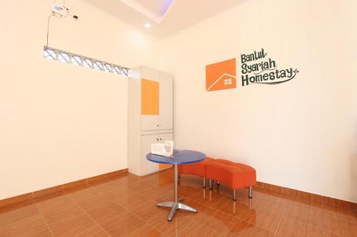 a room with a table and a chair in it at Homestay Syariah Bantul in Bantul