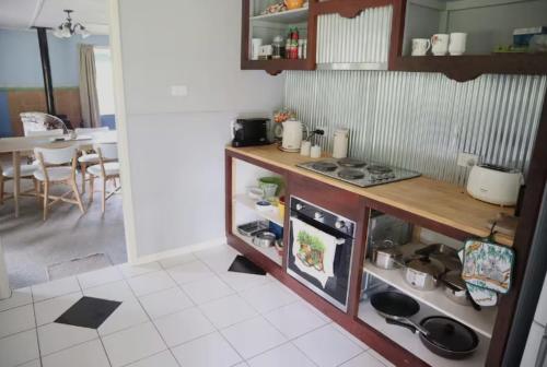a kitchen with a counter and a stove top oven at Winganna Farm in Peel