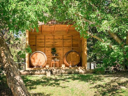 a wooden cabin with two wine barrels in the yard at Stanthorpe Holiday Park in Severnlea