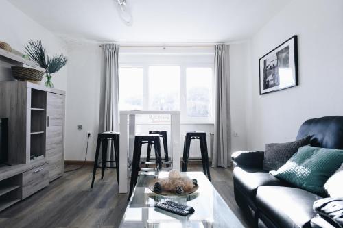 a living room with a couch and a table at Oberwiesenthal Apartments in Kurort Oberwiesenthal