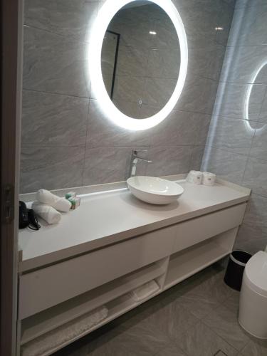 a bathroom with a sink and a mirror at Hibiscus Suites And Residences in Nadi