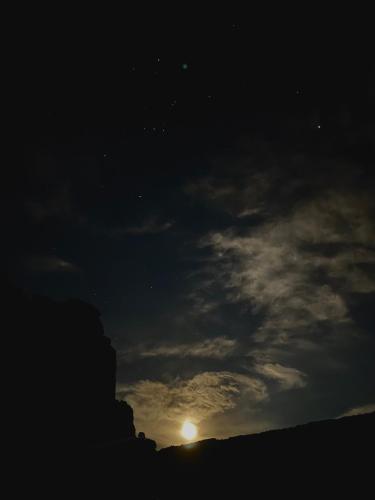 a night sky with the moon and clouds at Hotel Valle Colorado in Villa Unión