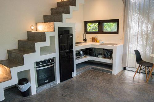 a living room with a spiral staircase in a house at BarriOceano in El Paredón Buena Vista
