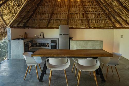a dining room with a wooden table and chairs at BarriOceano in El Paredón Buena Vista