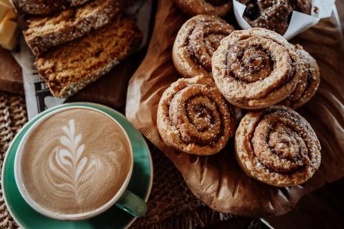 a plate of pastries and a cup of coffee at Lake Mahinapua Hotel in Ruatapu