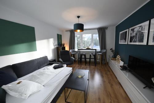 a living room with a couch and a table at Oberwiesenthal Apartments in Kurort Oberwiesenthal