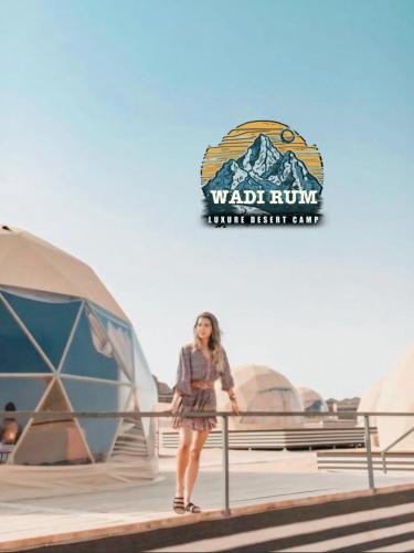 a woman standing in front of a tent at Wadi Rum Luxure desert Camp in Wadi Rum