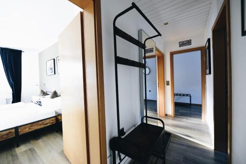 a room with a mirror and a bed and a chair at Oberwiesenthal Apartments in Kurort Oberwiesenthal