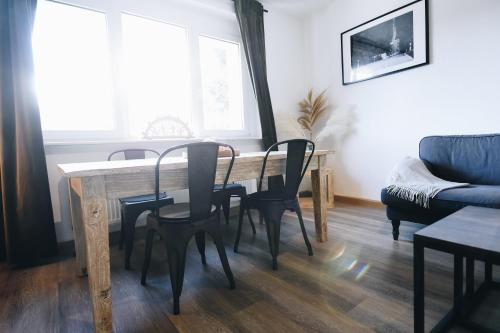 a living room with a table and chairs and a couch at Oberwiesenthal Apartments in Kurort Oberwiesenthal