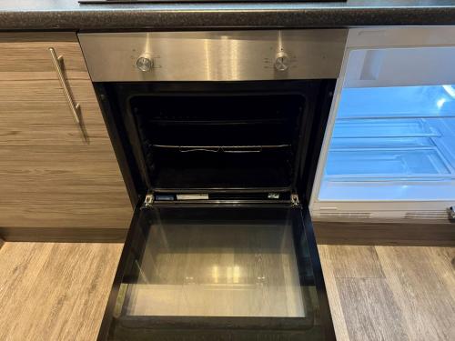 an empty oven with its door open in a kitchen at Liverpool One City Centre Studio Apartment in Liverpool