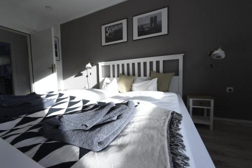 a bedroom with a bed with a blanket on it at Oberwiesenthal Apartments in Kurort Oberwiesenthal