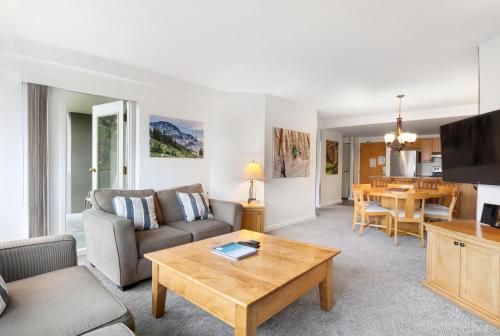 a living room with a couch and a table at The Woodrun Lodge by Whiski Jack in Whistler