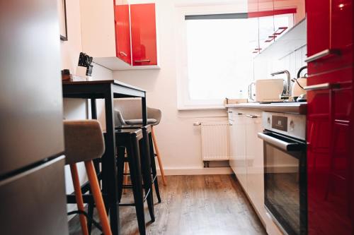 a kitchen with red cabinets and a counter top at Oberwiesenthal Apartments in Kurort Oberwiesenthal