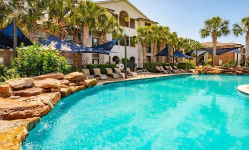 a swimming pool in a yard with chairs and a house at Beautiful 2 BR 2 BA, NRG, Medical Center, Downtown, Free WiFi, Pool in Houston
