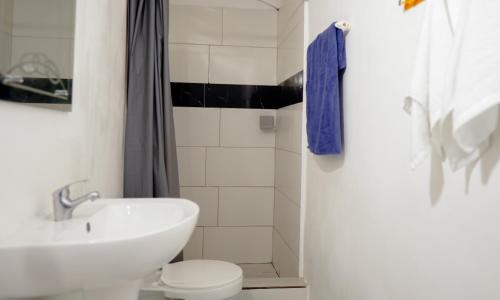 a white bathroom with a sink and a toilet at Casa Ballenas3 SF in Las Terrenas