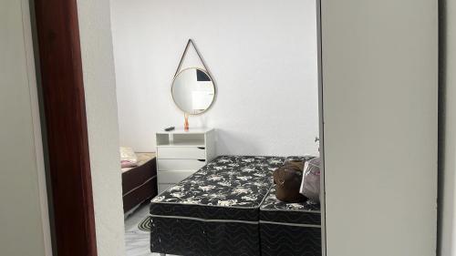 a bedroom with a mirror and a bed with a dresser at Lar do Mar in Salinópolis